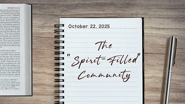 a notebook on a table next to a pen. Journal entry dated October 22, 2025. Entry titled "A Spirit-Filled community"